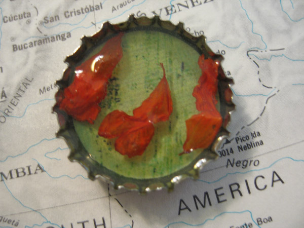 Ice resin bottlecap with flower inclusions by Nikki